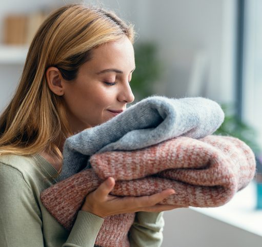woman enjoying softness of laundered towels