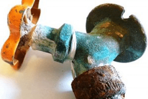 plumbing shut off valve showing blue-green build-up on pipes