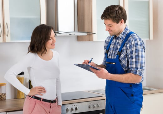 home buyer talking to inspector in kitchen