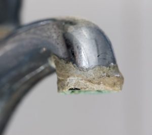 Close-up of limescale build-up on faucet